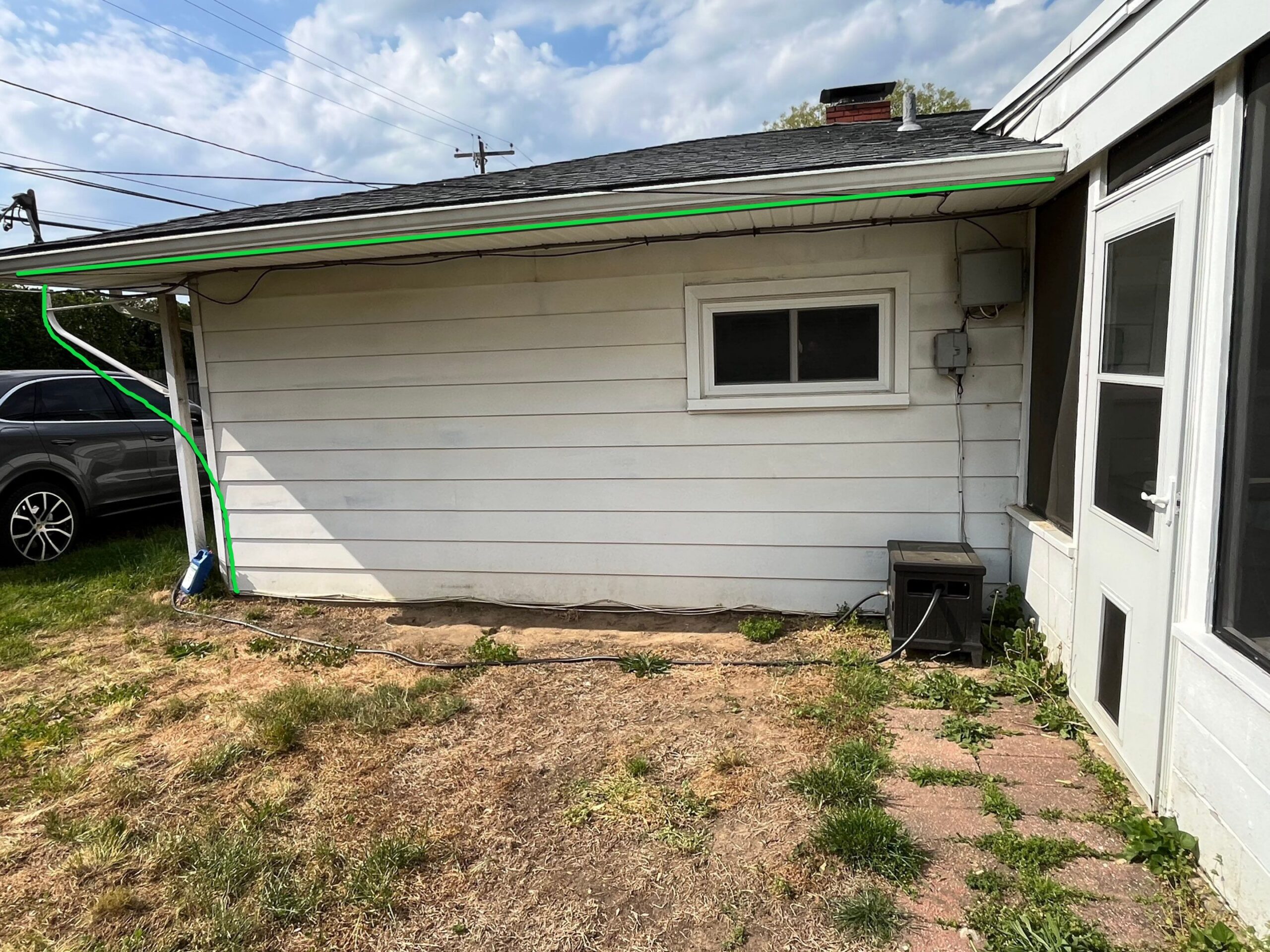 Side of the house showing old siding before replacement