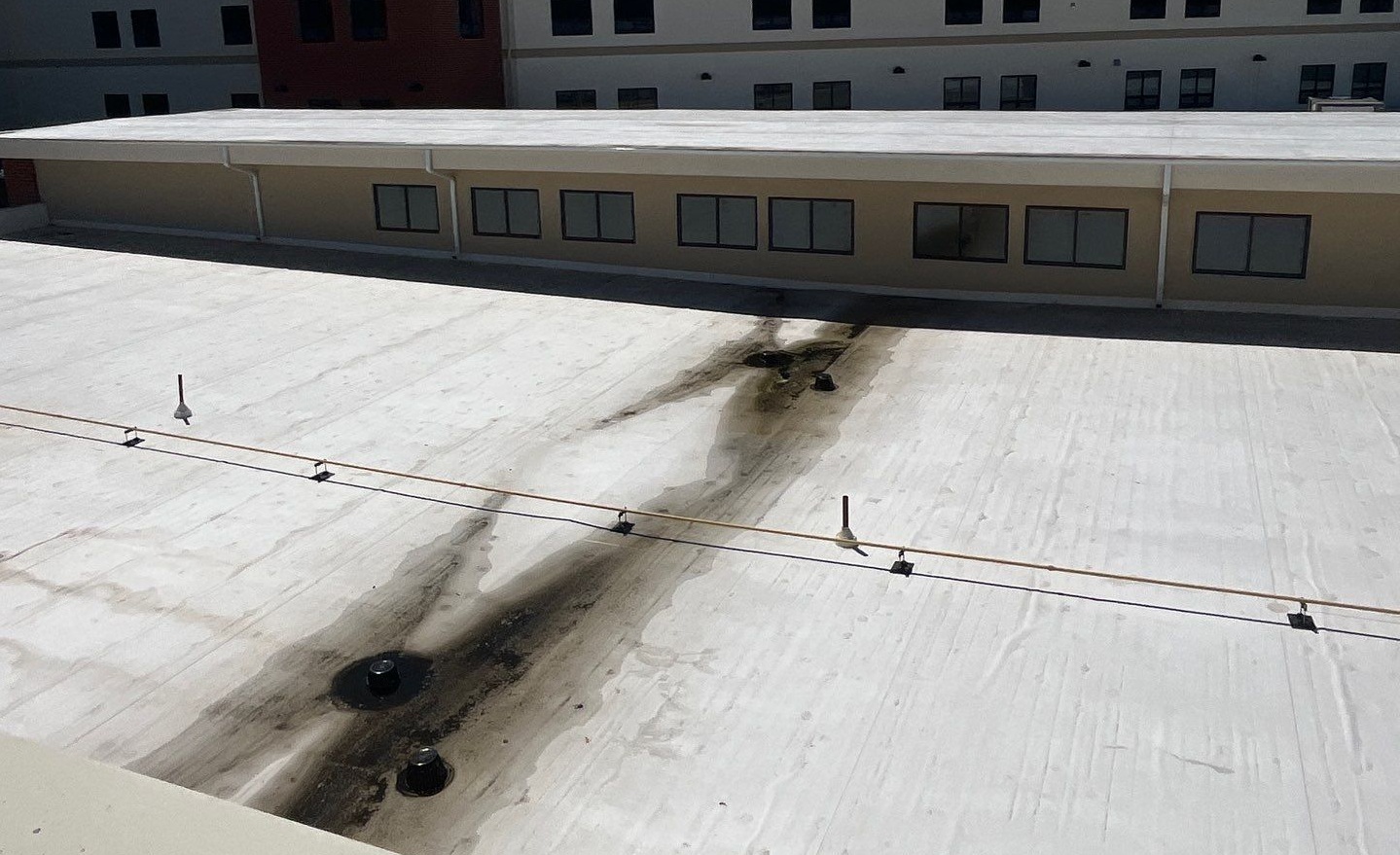 Commercial flat roof showing drainage issues and ponding water in Newark