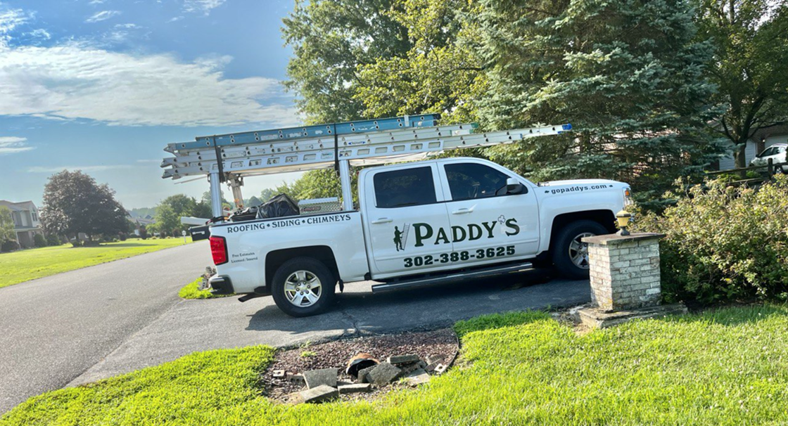 White Paddy's Chevrolet work truck parked on driveway of job site in Newark