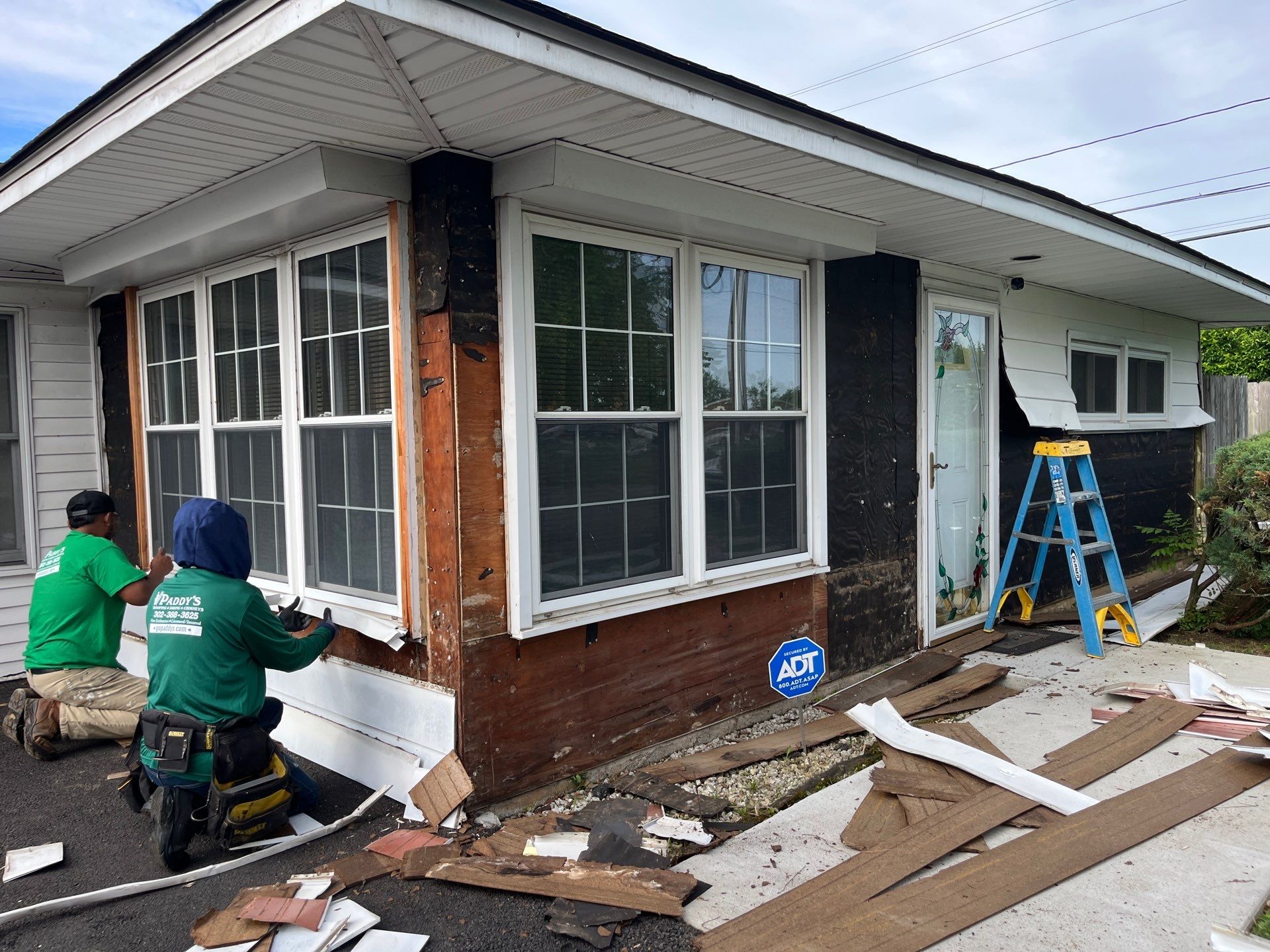 Paddy's siding professionals removing old damaged siding for replacement in Newark DE