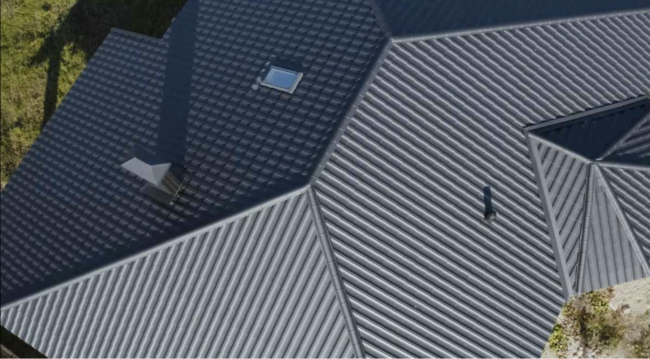 Closeup aerial view of a dark gray residential metal roof