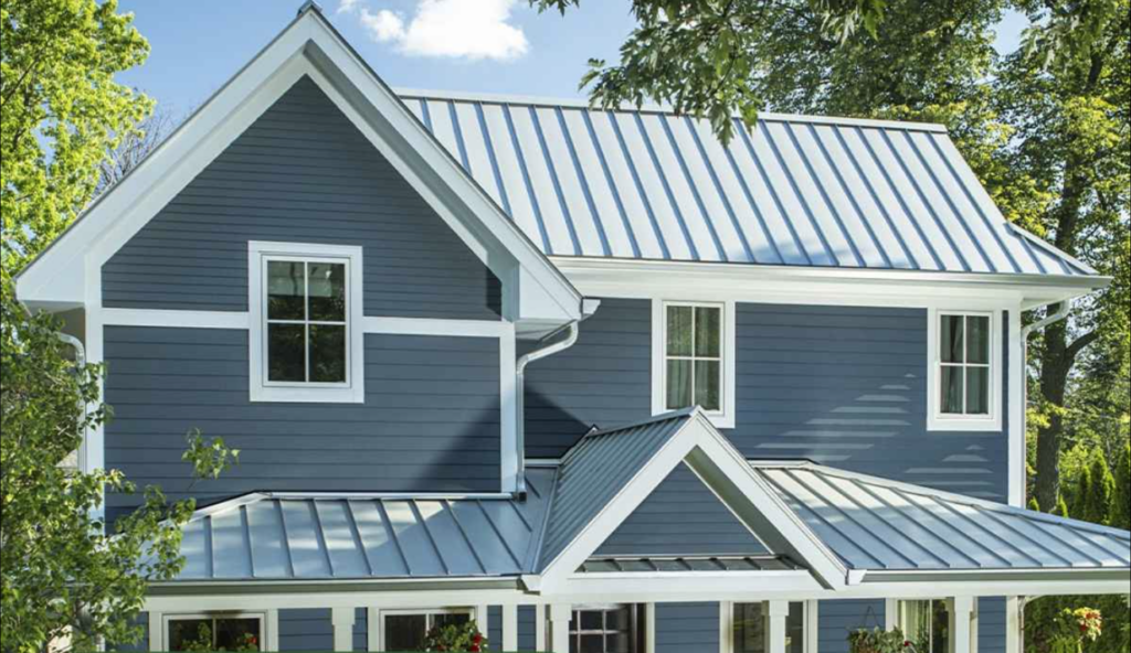 Exterior of a two story home with gray siding and metal roof