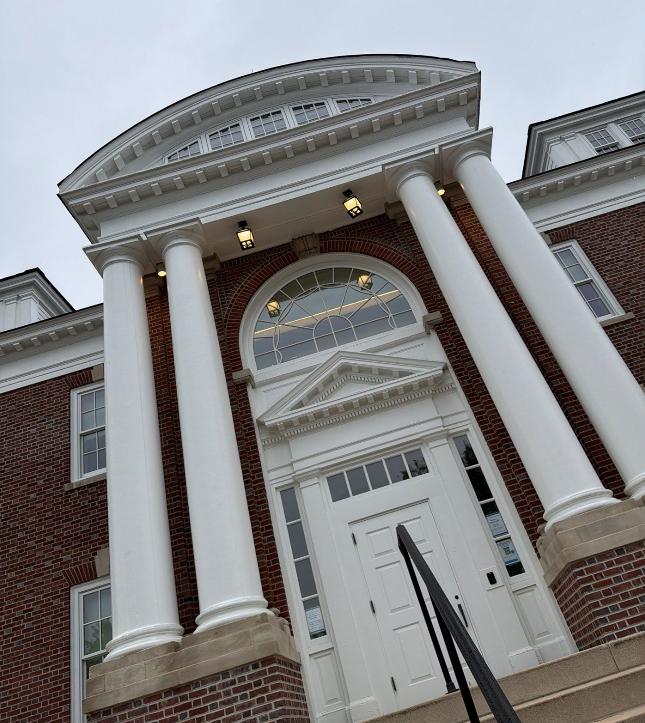 Tall white pillars at the entrance of the Warner Hall at the University of Delaware