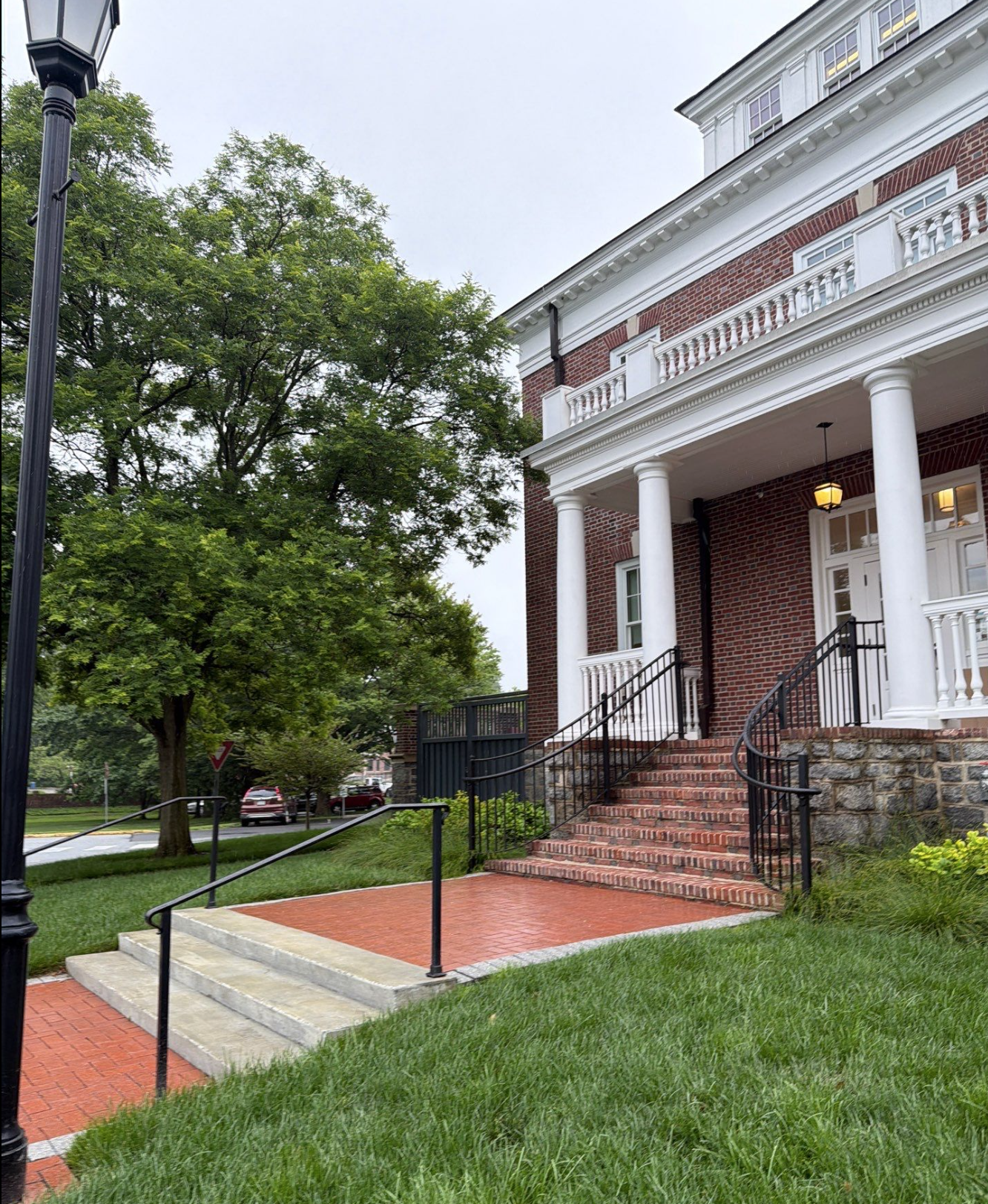 Entrance to the Warner Hall at University of Delaware with orange pavers and brick stairs