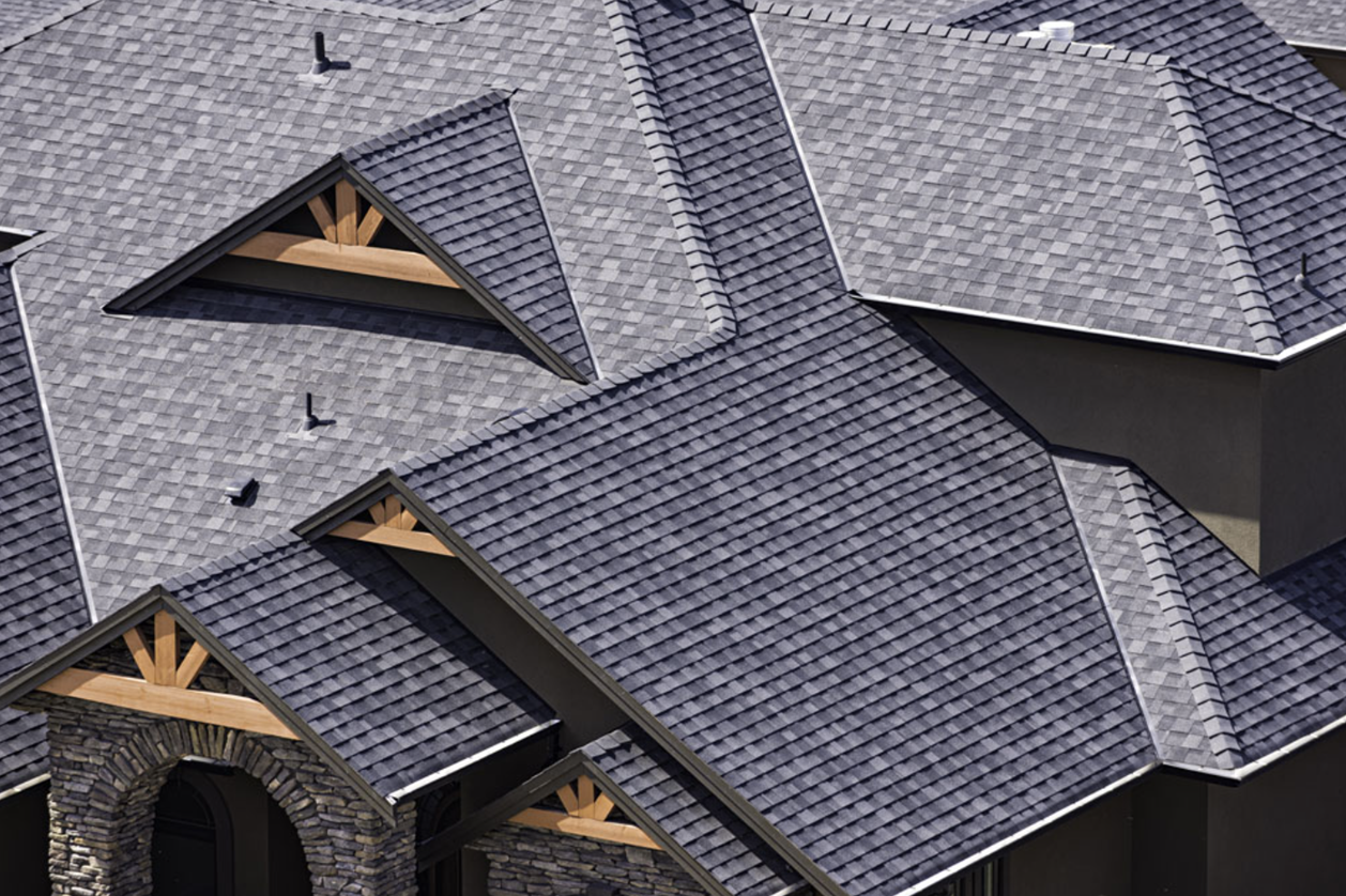 Top of a large home with asphalt shingle roof.