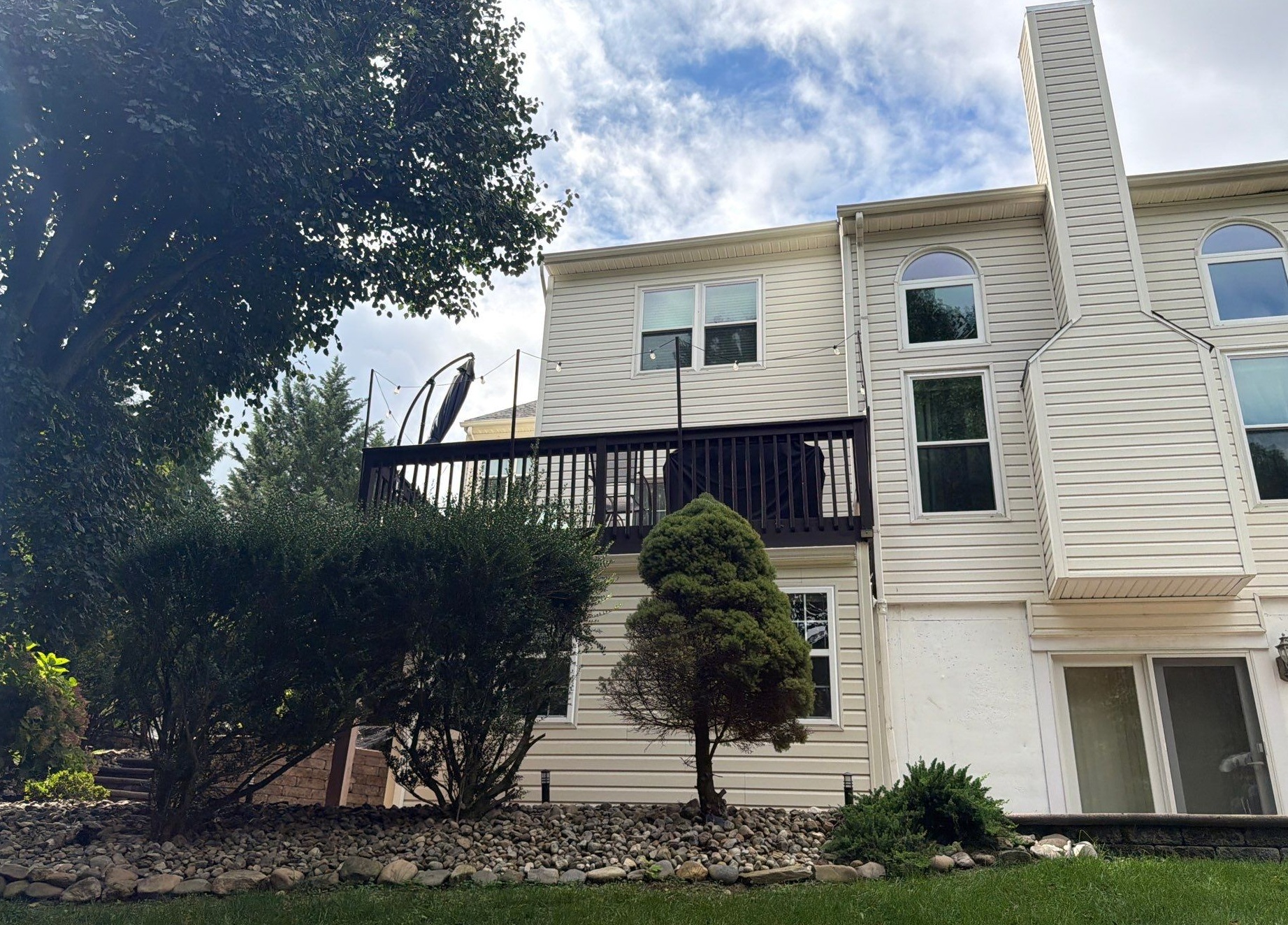 Two story home in Wilmington DE with beige siding and fireplace